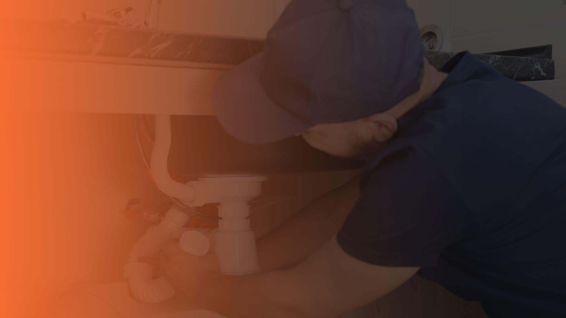 man fixing sink