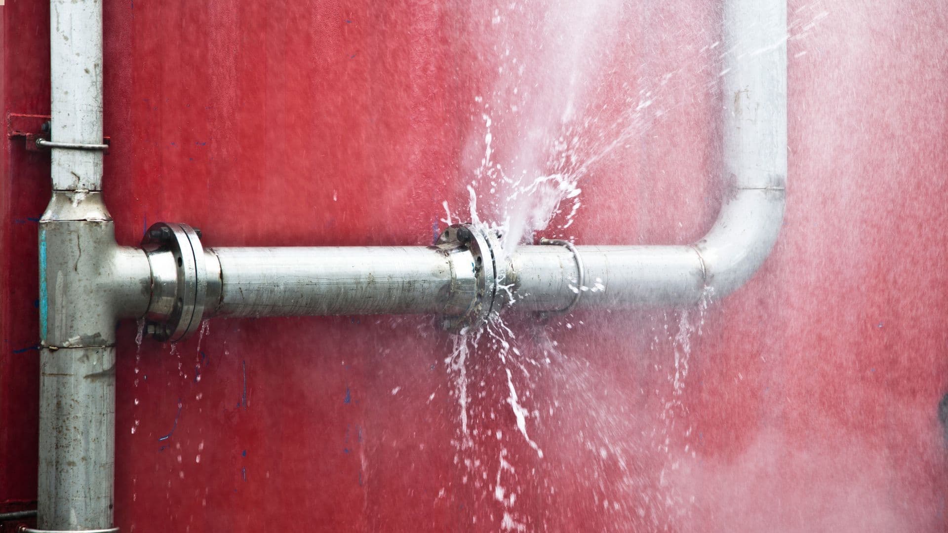 broken pipe on red wall
