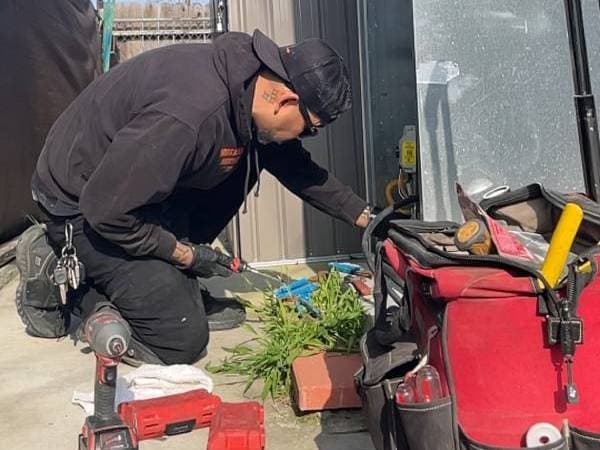 plumber with red bag